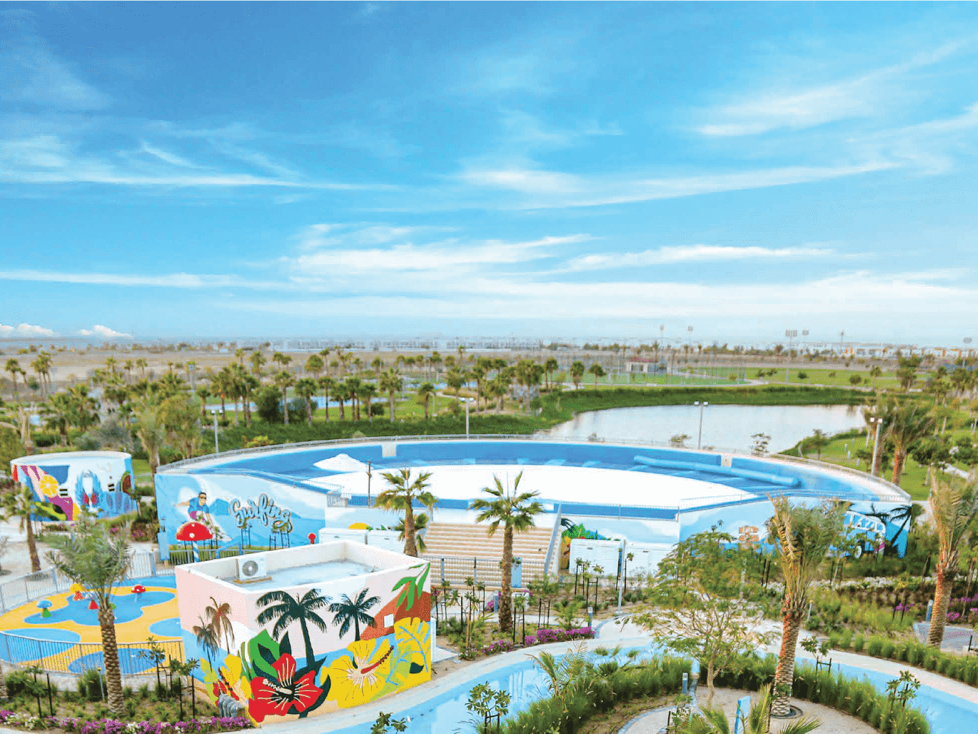 The image shows the Malibu Bay artificial beach, the lazy river, the wave surfing pool, and the floating pool.