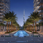 Four sleek residential towers of Address Residences Zabeel by Emaar Properties, overlooking greenery and Dubai’s skyline at dusk, including DIFC and Downtown
