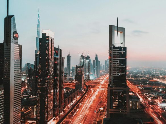 time lapse photography of passing vehicles on city roads